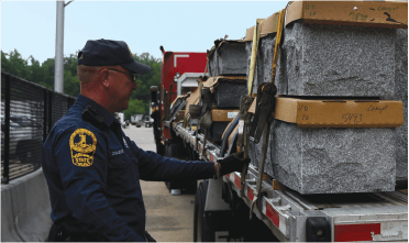 Highway patrol Officer inspecting cargo on truck
